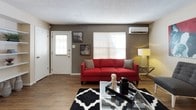 This single-floor residence offers a thoughtfully designed layout that balances comfort and practicality across several distinct living areas. The kitchen features dark espresso cabinetry contrasted by light countertops, wood-look flooring, and white appliances including a refrigerator and dishwasher, creating a clean and functional workspace. Adjacent to the kitchen, the dining area makes a bold statement with a vivid red accent wall, a ceiling fan, and wood-look flooring, providing an inviting space for meals. The living room continues the warm aesthetic with the same durable flooring, a wall-mounted mini-split HVAC unit, and a front entry door with a sidelight window that brings in natural light. Each bedroom is carpeted for comfort and features a ceiling fan, textured accent walls in deep tones, and ample closet space, including a mirrored sliding-door closet in one of the bedrooms. A window in each bedroom allows for natural light and ventilation. The bathroom includes a wide vanity with light countertops, dark cabinetry, and a large mirror with integrated lighting, offering a clean and practical space. Throughout, textured ceilings and a consistent neutral-and-bold color palette give the residence a cohesive and contemporary character.