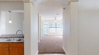 Located at 75 Riverfront Dr in North Little Rock, AR, this well-appointed 2-bedroom, 2-bathroom residence offers a thoughtfully designed single-floor layout. Elegant arched doorways connect the main living areas, creating a sense of architectural continuity throughout. The living room is bright and inviting, featuring plush carpet, a ceiling fan, and large windows with blinds that allow generous natural light. A standout built-in shelving unit with an arched display niche adds both character and functional storage to the living space. The kitchen is equipped with warm wood cabinetry, dark granite countertops, hardwood-style flooring, and black appliances, flowing seamlessly through an arched passageway into the dining area. Both bedrooms are carpeted and include ceiling fans and ample natural light. The primary bedroom offers access to a spacious walk-in closet with wire shelving. The primary bathroom features tile flooring, a glass-enclosed shower, rich wood vanity cabinetry, granite countertops, and a dual-sink layout. A second well-sized closet with wire shelving provides additional storage. Throughout the residence, neutral tones and clean finishes create a cohesive, comfortable atmosphere.