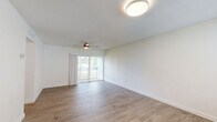Located at 2901 Beachwood Blvd in Jacksonville, Florida, this 2-bedroom, 1-bathroom residence offers a thoughtfully designed single-level layout. The open-concept living and dining area is a welcoming focal point, finished with warm wood-look flooring, crisp white walls, and a textured ceiling. A ceiling fan adds comfort, while a sliding glass door leads to a private balcony overlooking lush greenery, allowing natural light to fill the space. Adjacent to the living area, the kitchen is well-equipped with rich dark wood cabinetry, white countertops, stainless steel appliances including a range, microwave, and dishwasher, and a double-basin sink — providing ample storage and functionality. The primary bedroom is generously sized, featuring a ceiling fan, a natural-light window, and a built-in closet. The second bedroom mirrors this comfortable feel with its own ceiling fan and window view. Both bedrooms continue the wood-look flooring found throughout the home. The full bathroom is clean and functional, offering a combined tub and shower with built-in shelving, a vanity, and tile flooring. A hallway connects all areas cohesively, completing this practical and comfortable Jacksonville residence.