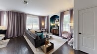 Located at 12330 N Gessner Rd in Houston, TX, this thoughtfully designed 2-bedroom, 3-bathroom single-story home offers a compelling blend of functional layout and bold interior design. The living room immediately captures attention with its rich dark hardwood flooring, multiple large windows flooding the space with natural light, and a dramatic teal-painted arched alcove serving as a striking focal point. Floor-length drapes in soft lavender tones complement the sophisticated aesthetic throughout.

The kitchen is outfitted with white shaker cabinetry, granite countertops, a subway tile backsplash, and stainless steel appliances, opening seamlessly toward the living and dining areas. The primary bedroom features plush carpeting, a dramatic floor-to-ceiling upholstered accent wall, a ceiling fan, and generous closet space. The second bedroom continues the stylish theme with neutral tones and ample natural light. Two dedicated closets provide practical storage solutions throughout.

Three well-designed bathrooms include granite vanity countertops with undermount sinks and a tub-shower combination with a curved curtain rod and clean white tile surround. The exterior entry features a private patio framed by natural stone columns, metal railings, and lush mature landscaping, creating an inviting and serene arrival experience.