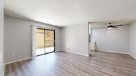 Located at 2700 Iowa Ave in Riverside, California, this single-story, 3-bedroom, 2-bathroom home offers a practical and well-organized layout. The living room is a bright, open space finished with light wood-style flooring and neutral gray walls, drawing natural light through a sliding glass door that leads directly to a private patio — ideal for indoor-outdoor living. The adjacent dining area flows naturally from the living space, creating a cohesive common area.

The kitchen features white cabinetry with black hardware, light countertops, a gas range, stainless steel refrigerator, and a window above the sink that provides additional natural light. A dedicated dining room sits nearby, offering a defined space for meals.

The three bedrooms are carpeted in soft gray tones, providing comfort underfoot. The primary bedroom offers a generous footprint with ample wall space. Additional bedrooms each include windows for natural light and ventilation. Two closets serve the bedroom areas, and a hallway connects the private quarters to the shared living spaces.

Both bathrooms are finished with wood-look tile flooring, white tub-shower combos, and cream-toned vanities with black hardware accents. The clean, updated aesthetic is consistent throughout the home, making it a move-in ready residence in the heart of Riverside.
