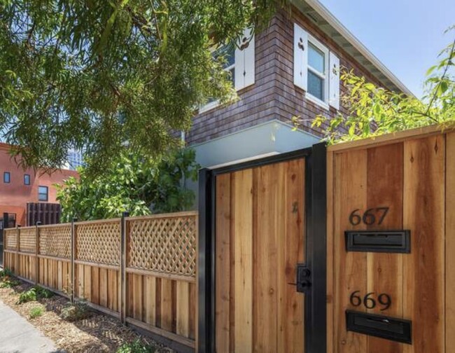 Securely gated front door to duplex with secure mailboxes for both units - 667 40th St