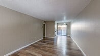 Located at 8200 Viscount Blvd in El Paso, Texas, this single-floor, one-bedroom, two-bathroom unit offers a practical and well-organized layout. Throughout the space, wood-look laminate flooring provides a warm, cohesive aesthetic, complemented by neutral taupe-toned walls and white trim. Textured ceilings add a classic finish consistent across all rooms.

The living room is an open, light-filled space with a white paneled entry door, adjacent window with blinds, and vertical shiplap-style wall paneling — a standout design detail that adds texture and character. This area flows naturally toward the combined dining room and kitchen, which features a sliding glass door that brings in additional natural light and outdoor views.

The bedroom offers a comfortable, private retreat with a window, wood-look flooring, and access to three closets, providing generous storage throughout the unit. The two bathrooms are cleanly finished with white cabinetry, matching flooring, and functional fixtures, offering both practicality and convenience.

The overall ambiance is clean, neutral, and move-in ready, with a straightforward floor plan that maximizes the use of its compact footprint. This unit is well-suited for those seeking a simple, functional living space in the El Paso area.