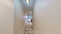 Located at 3020 Billy Jack Dr in Conway, Arkansas, this single-story, 2-bedroom, 2-bathroom home offers a practical and comfortable layout across a well-utilized floor plan. The entrance leads into a hallway finished with light tile flooring and crown molding, connecting the main living areas seamlessly. The spacious living room features plush carpet, a ceiling fan with light fixture, and crown molding, opening directly into the combined dining room and kitchen. The kitchen is equipped with warm oak cabinetry, a peninsula countertop with ample workspace, a built-in sink, white electric range, black refrigerator, and a built-in microwave — all finished with light tile flooring. The primary bedroom is generously sized, filled with natural light from a window, carpeted floors, a ceiling fan, and access to two closets. The second bedroom also features carpet, a ceiling fan, and its own closet. Both bathrooms include tub/shower combinations with sliding glass enclosures and tile flooring. Additional highlights include a dedicated laundry room, a utility room, and an attached garage with an automatic opener, textured ceiling, and concrete floors — offering excellent storage and parking capability. Six closets throughout the home provide exceptional storage.