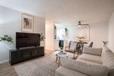 Located at 1319 159th Ave in San Leandro, CA, this 2-bedroom, 1-bathroom single-floor home offers a well-organized and thoughtfully designed layout. The open-concept living and dining area is bright and welcoming, featuring light wood-style flooring, a textured ceiling, and a large window that invites natural light into the space. The living room flows seamlessly into the dining area and kitchen, creating a connected and functional common area.

The kitchen is efficiently designed with a galley-style layout, showcasing white cabinetry with matte black hardware, light quartz-style countertops, and black appliances including a refrigerator, range, microwave, and dishwasher. A skylight-style overhead fixture adds brightness to the space.

Both bedrooms are carpeted and offer a comfortable, quiet retreat. The primary bedroom is generously sized and includes a sliding-door closet, while additional closets throughout the unit — three in total — provide excellent storage capacity. The bathroom features a clean, modern aesthetic with a white vanity, a large mirror, matte black fixtures, and a shower-tub combination.

The consistent light wood flooring in the main areas, neutral color palette, and modern finishes throughout give this home a cohesive and contemporary feel.