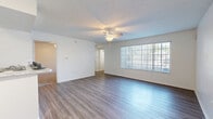 Located at 7009 Interbay Blvd in Tampa, FL, this single-story 2-bedroom, 2-bathroom home offers a practical and well-organized layout across a comfortable footprint. The open-concept living room greets you with wood-look flooring, a ceiling fan, and a large window fitted with vertical blinds that allows generous natural light to fill the space. It flows seamlessly into the kitchen, which features white cabinetry, marble-style countertops, a peninsula island, and white appliances including a refrigerator and range — an efficient and clean setup for everyday living.

Both bedrooms are carpeted and include ceiling fans, offering a cozy atmosphere. The primary bedroom provides a generous amount of space and is served by a walk-in closet with wire shelving. A second closet is also present elsewhere in the home. Each bathroom is finished with wood-look flooring, a tub/shower combo, and a vanity with marble-style countertops. One bathroom features accessibility-friendly grab bars in the shower area.

A dedicated laundry room houses a full-size washer and dryer and includes a window for ventilation. The home's clean, neutral palette and functional design make it a well-rounded residence in Tampa's Interbay neighborhood.
