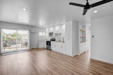 Located at 6933 Rosemead Blvd in San Gabriel, California, this thoughtfully updated single-floor unit offers a clean, modern aesthetic throughout. Light wood-look flooring runs seamlessly across every room, complementing the crisp white walls and recessed lighting that create a bright, airy atmosphere.

The open-concept kitchen is a standout feature, boasting white shaker cabinetry extending floor to ceiling, quartz-style countertops, a stainless steel range with overhead ventilation, and a double-basin sink. A sliding glass door from the kitchen area leads directly to a private balcony, filling the space with natural light and offering pleasant outdoor views of the surrounding neighborhood.

The living area is generously proportioned, featuring recessed lighting and a ceiling fan, providing a comfortable and versatile space. The bedrooms are well-sized, each with wood-look flooring, ceiling fans, and large windows dressed with vertical blinds that allow for abundant natural light. One bedroom includes a sliding glass door opening to a private balcony with neighborhood views, along with a built-in closet.

The bathroom is finished in a clean, all-white palette, featuring a tiled shower and tub combination, white cabinetry for storage, and a vanity with mirror. Every detail reflects a fresh, move-in-ready condition throughout this well-appointed San Gabriel residence.