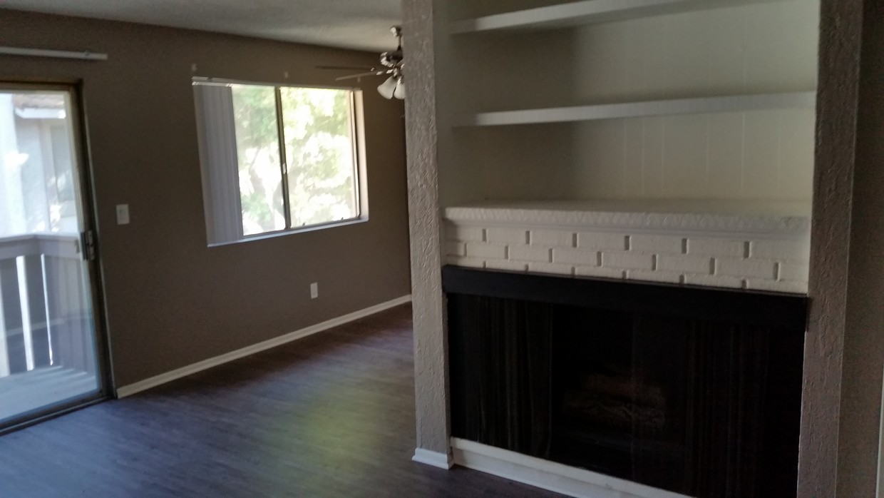 gas fireplace with shelves - Pinecrest Apartments