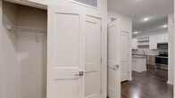 Located at 14350 Ambrosia Street in Tampa, FL, this thoughtfully designed one-bedroom, one-bathroom residence offers a clean, modern aesthetic throughout its well-utilized single floor. The open-concept kitchen and living area serves as the heart of the home, showcasing a large granite-topped island, a two-tone cabinetry scheme pairing crisp white upper cabinets with warm wood-finish lowers, a subway tile backsplash, and a full suite of stainless steel appliances including a refrigerator, range, microwave, and dishwasher. Recessed lighting and wood-style plank flooring extend throughout, providing a cohesive, contemporary look. The bedroom is a comfortable retreat featuring multiple windows dressed with white blinds, a ceiling fan, and direct access to a dedicated closet outfitted with wire shelving systems for organized storage. The bathroom is finished with matching granite countertops on the vanity, a tiled tub-shower combination, and wood-style flooring that ties the space together. Neutral wall tones and clean white trim are consistent throughout, creating a bright, move-in-ready environment well-suited for comfortable everyday living in the heart of Tampa.