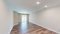 Located at 720 Charter Dr in Longs, SC, this single-story 2-bedroom, 2-bathroom home offers a well-designed, functional layout with consistent wood-look flooring throughout. A central hallway connects the living spaces, leading to an open-concept kitchen and living room combination. The kitchen is a standout feature, boasting rich dark-brown cabinetry, light granite countertops, a breakfast bar peninsula with seating, and a full suite of stainless steel appliances including a range, microwave, and refrigerator with ice maker. The spacious living room is filled with natural light from a large sliding glass door that opens to the outdoors, complemented by recessed lighting above. Both bedrooms are well-sized, each featuring wood-look flooring, neutral toned walls, and windows with blinds that bring in natural light. The generously sized primary bedroom offers ample space for furnishings. The two bathrooms are finished with dark vanity cabinetry, white countertops, brushed nickel fixtures, and tub-shower combinations. A dedicated utility room provides added convenience. Clean lines, neutral tones, and recessed lighting throughout give the home a fresh, move-in-ready feel.