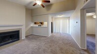 This 550 square foot, single-story apartment in Amarillo, Texas offers a compact yet functional living space. The unit features one bedroom and one bathroom, ideal for a single occupant or couple. The kitchen is equipped with modern appliances, including a stainless steel refrigerator and range, complemented by wooden cabinetry. The living area boasts a fireplace, adding warmth and character to the space. Throughout the apartment, you'll find a mix of flooring, with wood-look laminate in the kitchen and bathroom, and plush carpeting in the living room and bedroom. Ceiling fans and ample windows provide good air circulation and natural light. The bathroom features a single vanity and a bathtub/shower combination. A sliding glass door in the living area suggests potential outdoor access, possibly to a small patio or balcony. The neutral color palette throughout allows for easy personalization. Despite its compact size, the layout appears to make efficient use of the available space, creating a cozy and inviting atmosphere.
