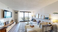 Located at 1730 N Clark St in Chicago's vibrant Lincoln Park neighborhood, this one-bedroom, one-bathroom residence offers a well-designed layout across a single floor. Hardwood-style flooring runs throughout the unit, lending a cohesive, contemporary feel from room to room.

The entry hallway opens into a combined living and dining area that serves as the heart of the home. The living space is bright and airy, anchored by large floor-to-ceiling sliding glass doors that lead to a private balcony, framing sweeping outdoor views. The dining area connects seamlessly to the kitchen via a built-in pass-through with a breakfast bar — a practical and stylish detail ideal for casual dining.

The kitchen features white cabinetry extending to the ceiling for ample storage, stainless steel appliances including a full-size refrigerator, dishwasher, and range, and clean white countertops complemented by a subway tile backsplash.

The spacious primary bedroom is a comfortable retreat with large windows offering expansive views, a walk-in closet, and direct access to the bathroom. The bathroom includes a dark wood vanity with a white countertop, tile flooring, and a clean, neutral color palette.

Two closets provide additional storage throughout the unit, completing this thoughtfully laid-out Chicago residence.
