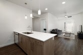 This 4-bedroom, 2-bathroom unit in Idaho Falls, Idaho offers a thoughtfully designed single-floor layout that balances functionality and modern style. The open-concept kitchen and living area serves as the heart of the home, where a sleek peninsula with a white quartz countertop and bar seating flows seamlessly into the living room. The kitchen is equipped with stainless steel appliances, including a refrigerator, range, and microwave, complemented by light wood cabinetry and pendant lighting overhead. Wood-look flooring extends throughout the main living areas, adding warmth and continuity.

The living room is bright and welcoming, featuring a ceiling fan, a large exterior door with sidelights that invite natural light, and an open, airy feel. Each of the four bedrooms is carpeted and offers ceiling fans and windows with blinds for comfort and privacy. The spacious primary bedroom includes direct outdoor access through a glass door, enhancing its appeal.

Both bathrooms are finished with clean, contemporary details: warm wood vanities, white quartz countertops, large mirrors with modern lighting fixtures, and wood-look tile flooring. One bathroom features a full soaking tub and shower combination. The unit also includes a dedicated closet for additional storage, rounding out this practical and attractive living space.