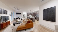 Located at 1879 Village West Pkwy in Kansas City, KS, this 2-bedroom, 2-bathroom residence offers a thoughtfully designed single-floor layout with a bright, contemporary aesthetic. The open-concept living and kitchen area serves as the heart of the home, anchored by light wood-look flooring, crisp white walls, and a ceiling fan that enhances the airy feel. Large windows throughout admit generous natural light, creating a welcoming atmosphere.

The kitchen is well-equipped with rich dark cabinetry, a subway tile backsplash, stainless steel appliances including a French door refrigerator, and a white quartz-topped island with bar seating beneath industrial-style pendant lights. The living area flows seamlessly from the kitchen and dining space, offering room for multiple seating arrangements and a dedicated dining nook with exterior door access.

The primary bedroom is a comfortable retreat with carpeted flooring, a large window overlooking the outdoors, and dedicated closet space. The primary bathroom features a glass-enclosed walk-in shower with tile surround and a wood-toned vanity. The second bathroom mirrors the modern finishes with a full tub-shower combo and matching cabinetry. Two closets provide practical storage throughout the residence.