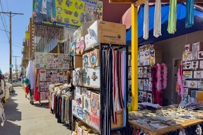 You can buy finished clothes or fabrics and thread in the Fashion District.