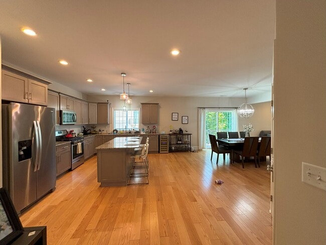 Main floor, kitchen with stainless steel appliances & granite countertops, opens into dining/living - 140 Wells View Rd