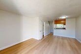 Located at 1106 Prospect in Santa Rosa, CA, this two-story residence offers a well-organized layout spread evenly across two floors. The main level features an open living and dining area finished with light hardwood-style flooring and textured ceilings, creating a bright and airy atmosphere. Sliding glass doors allow natural light to fill the living space and provide access to an outdoor patio area. The galley-style kitchen is efficiently designed with warm wood cabinetry, dark countertops, stainless steel appliances including a gas range, dishwasher, and refrigerator, plus a stainless sink — maximizing functionality within a compact footprint. A convenient bathroom on the main floor features a unique angled ceiling detail, wood-tone cabinetry, and hardwood-style flooring. Carpeted stairs lead to the upper level, where two bedrooms provide comfortable retreats, each with plush carpet flooring, closets, and windows offering views of surrounding greenery. The primary bedroom is a well-proportioned space with ample natural light. Two additional bathrooms, including a full bath with a soaking tub, serve the upper level. Utility rooms and hallways complete the practical layout of this efficiently designed two-story home.