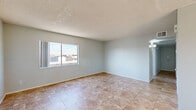 Located at 6575 W Ocotillo Rd in Glendale, Arizona, this single-floor, three-bedroom, one-bathroom home offers a practical and comfortable layout. Consistent large-format tile flooring runs throughout every room, lending a cohesive and easy-to-maintain aesthetic across the entire space.

The kitchen is well-appointed with white cabinetry, white countertops, and stainless steel appliances including a refrigerator, electric range, dishwasher, and a range hood. A double-basin sink sits beneath a bright, open layout that makes the space functional and efficient.

The living room is bright and open, featuring a ceiling fan, multiple windows that invite natural light, and sliding glass doors that open onto an outdoor balcony area. The three bedrooms are each finished with the same tile flooring and neutral light gray walls, providing a clean, move-in-ready environment. Several bedrooms include sliding or paneled closet doors for storage. Windows in each bedroom offer natural light and exterior views.

The bathroom is clean and straightforward, featuring a white vanity with a mirror, a toilet, and matching tile flooring. A hallway connects the bedrooms and bathroom, creating a logical and efficient flow throughout the home. The textured ceilings are consistent throughout, adding a classic touch to the overall design.