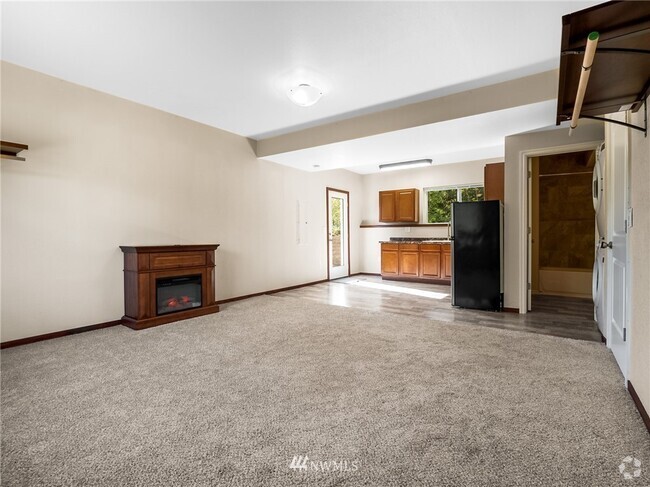 From back corner showing electric fireplace on the right, kitchen in the middle and washer and dryer - 10306 41st Trl SE