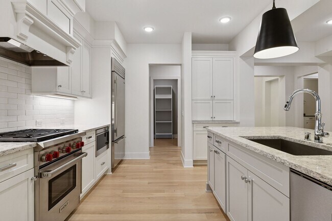 Kitchen highlights include high-end SS appliances, gas range, and tiled backsplash - 222 Ferndale Rd S