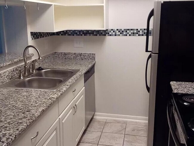 View of fully loaded kitchen from the hallway. - 8435 Hearth Dr