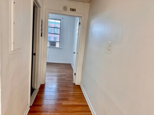 Hallway connecting the living room to the bedroom. - 353 High St