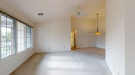 Located at 8734 Westlake Dr in Greendale, Wisconsin, this single-floor home offers a thoughtfully designed layout with a bright, open feel throughout. The living area is generously proportioned, featuring vaulted ceilings, soft carpeting, and a ceiling fan that enhances airflow and comfort. Large windows invite abundant natural light, creating a warm and airy atmosphere. A pendant light fixture adds a refined touch to the dining area, which flows seamlessly into the kitchen via an open passageway. The kitchen is well-equipped with white cabinetry offering ample storage, laminate countertops, a full suite of white appliances including a range, built-in microwave, and refrigerator, and durable wood-look flooring. A peninsula counter provides additional workspace and casual seating. The eat-in dining nook features an arched multi-pane window that frames outdoor views, enhancing the space with natural light. The home includes two full bathrooms: one with a glass-enclosed walk-in shower and tile flooring, and another with a soaking tub/shower combination, a vanity, and tile floors. Closet storage is available in the main living areas. The home's neutral color palette and vaulted ceilings throughout contribute to a spacious, welcoming ambiance.