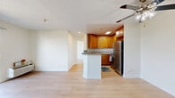 Located at 6835 Laurel Canyon Blvd in North Hollywood, Los Angeles, this 2-bedroom, 2-bathroom residence offers a well-designed single-floor layout. The open-concept living and kitchen area serves as the heart of the home, featuring warm honey-toned wood cabinetry, granite-style countertops, stainless steel appliances including a refrigerator and dishwasher, and a peninsula with breakfast bar seating. Light wood flooring runs throughout, complemented by a textured ceiling and ceiling fan. The primary bedroom is generously sized, offering sliding glass doors that open to an outdoor balcony with peaceful treetop and neighborhood views, plus a wall-mounted HVAC unit for climate control. The second bedroom features a mirrored sliding closet and a bright window framing scenic outdoor views. Both bathrooms are clean and functional — one with a white vanity and shower, the other with a full tub-shower combination and chrome fixtures. The space maintains a bright, neutral palette throughout, with natural light flowing in from multiple windows. A dedicated closet provides additional storage, rounding out this practical and comfortable Los Angeles residence.