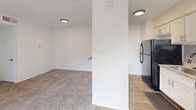 Located at 4720 Wellesley Ave in Fort Worth, TX, this single-floor, 2-bedroom, 1-bathroom residence offers a functional and well-organized layout. The kitchen is a standout feature, showcasing white shaker-style cabinetry, granite countertops, a subway tile backsplash, a stainless steel sink with a matte black faucet, and wood-look flooring — providing a clean, modern aesthetic. The kitchen opens toward the living area, which is carpeted and illuminated by flush-mount ceiling fixtures, creating a cohesive and comfortable common space. Both bedrooms are carpeted and feature ceiling fans with light kits, windows with blinds for natural light, and textured ceilings. The primary bedroom includes access to a walk-in closet with built-in shelving, as well as an additional closet for ample storage. The second bedroom features a bi-fold door closet. The bathroom is finished with granite countertops, white cabinetry, wood-look tile flooring, and a full shower-tub combo with white tile surround. A hallway connects the living spaces efficiently. The unit also includes a dedicated closet for additional storage. The exterior, visible in the 3D scan, is surrounded by mature trees, adding a natural, shaded setting to the property.