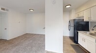 Located at 4720 Wellesley Ave in Fort Worth, TX, this single-floor, 2-bedroom, 1-bathroom residence offers a functional and well-organized layout. The kitchen is a standout feature, showcasing white shaker-style cabinetry, granite countertops, a subway tile backsplash, a stainless steel sink with a matte black faucet, and wood-look flooring — providing a clean, modern aesthetic. The kitchen opens toward the living area, which is carpeted and illuminated by flush-mount ceiling fixtures, creating a cohesive and comfortable common space. Both bedrooms are carpeted and feature ceiling fans with light kits, windows with blinds for natural light, and textured ceilings. The primary bedroom includes access to a walk-in closet with built-in shelving, as well as an additional closet for ample storage. The second bedroom features a bi-fold door closet. The bathroom is finished with granite countertops, white cabinetry, wood-look tile flooring, and a full shower-tub combo with white tile surround. A hallway connects the living spaces efficiently. The unit also includes a dedicated closet for additional storage. The exterior, visible in the 3D scan, is surrounded by mature trees, adding a natural, shaded setting to the property.