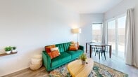 Located at 2239 Railroad St in Pittsburgh's vibrant Strip District, this thoughtfully designed studio offers a smart, efficient layout that maximizes every square foot. The space is accessed through a clean entry corridor with recessed lighting and light wood-tone flooring that continues throughout, creating a cohesive and airy feel.

The open-concept main living area seamlessly integrates the sleeping, living, and dining zones. Large windows and a sliding glass door flood the space with natural light and provide access to a private balcony, offering views of the surrounding neighborhood. The kitchen is fully equipped with stainless steel appliances — including a full-size refrigerator, electric range, dishwasher, and microwave — complemented by white cabinetry and dark stone countertops. In-unit washer and dryer hookups are tucked neatly behind a sliding door adjacent to the kitchen. A mirrored sliding closet adds both storage and the illusion of additional depth to the sleeping area.

The bathroom features wood-look tile flooring, a vanity with dark countertops, a large mirror, and clean, modern fixtures, maintaining the contemporary aesthetic found throughout the unit. Recessed lighting and crisp white walls contribute to the bright, modern ambiance of this well-appointed Pittsburgh studio.