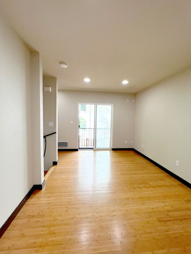 View of living area. Access to yard. Study nook/storage in left corner. - 4212 8th Ave NE