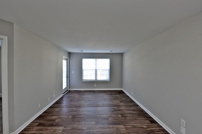 Spacious living room with hardwood-style flooring - Parc Fairview