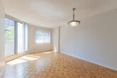 Located at 30 Elm Dr E in Mississauga, this 1-bedroom, 1-bathroom unit offers a thoughtfully organized floor plan that maximizes every square foot of its compact footprint. The interior is finished with warm parquet wood flooring throughout the main living areas, complementing the clean white walls and creating a bright, welcoming ambiance.

The kitchen is well-equipped with white shaker-style cabinetry extending to the ceiling for ample storage, a granite-tone countertop, a double sink, a black electric range, and a stainless steel refrigerator. Light tile flooring ties the space together, and a pass-through window connects the kitchen to the living area, where a pendant light fixture and a window allow natural light to flow in.

The bedroom is a comfortable size, featuring the same parquet flooring, vertical blinds on the window, a textured ceiling, and a built-in HVAC unit for climate control. The bathroom includes a full bathtub and shower combination with clean white tile surround. A dedicated laundry room provides added convenience. A hallway with parquet flooring connects the rooms, contributing to a cohesive and functional layout throughout the unit.