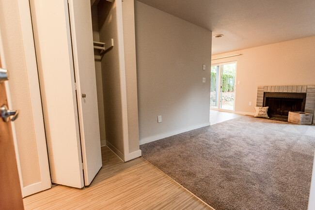 Tacoma Apartments - Notch8 Apartments - Entryway, Hall Closet, Living Room, Fireplace, and Patio - Notch 8