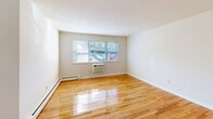 Located at 12 Koster Blvd in Edison, NJ, this single-floor, one-bedroom, one-bathroom residence offers a practical and well-organized layout. Gleaming hardwood floors run throughout the main living areas, lending warmth and a sense of continuity to the space. The combined living and dining room is generously proportioned, bathed in natural light through large windows, and features baseboard heating. A wall-unit air conditioner ensures year-round comfort. The kitchen is efficiently designed with warm wood cabinetry, white countertops, a stainless steel sink, and a window that invites natural light — providing a pleasant cooking environment. The bedroom is a comfortable size, featuring polished hardwood floors, a bright window, and an impressive four closets offering exceptional storage. The full bathroom is finished with white tile surrounding the tub and shower, a wood-vanity with a single sink, and a window for ventilation. Clean, neutral wall tones throughout the residence create a bright, move-in-ready atmosphere. With its well-maintained finishes and thoughtful layout, this Edison residence delivers functional living in a convenient New Jersey location.