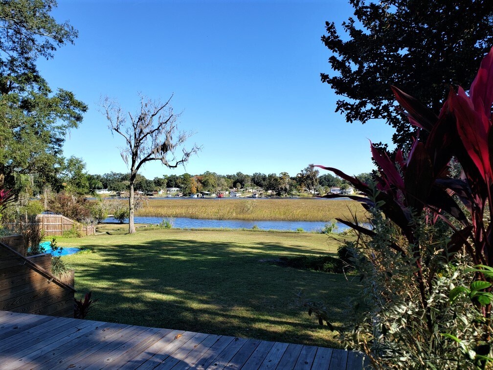 Kayak (included in rental) or stand up paddle board to the St. Johns River from the backyard - 6325 Kellow Dr