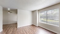 Located at 132 Fountain Oaks Cir in Sacramento, CA, this one-bedroom, one-bathroom unit offers a practical and well-organized single-level layout. Wood-look flooring runs throughout the space, providing a cohesive and easy-to-maintain aesthetic, while textured ceilings and neutral-toned walls create a clean, understated backdrop in every room.

The living area is bright and open, benefiting from a large window fitted with horizontal blinds that allow for controlled natural light and views of the surrounding greenery. A front entry door with an adjacent sidelight window adds additional brightness to the entry hallway.

The kitchen is efficiently arranged with warm-toned wood cabinetry extending to the upper walls for ample storage, and includes white appliances — a refrigerator, electric range, dishwasher, and sink — making it fully functional for everyday use.

The bedroom is a comfortable size, featuring its own window for natural light, a dedicated walk-in closet with built-in shelving, and direct access to the hallway. The bathroom is straightforward and clean, equipped with a full tub-shower combination, toilet, and hard flooring that mirrors the rest of the unit.

A hallway connects the main living areas efficiently, contributing to the unit's well-considered and compact flow.