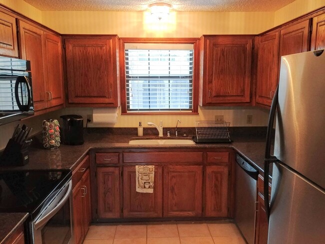 The kitchen is complete with all appliances and utensils you'll need for home-cooked meals! - 2415 Idlewilde Dr