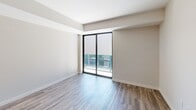 Located at 500 N Andrews Ave in the heart of Fort Lauderdale, this well-appointed one-bedroom, one-bathroom residence offers a thoughtfully designed open-concept layout finished with modern, high-quality materials throughout. Wide-plank wood-look flooring flows seamlessly across the entire unit, creating a cohesive and warm aesthetic.

The kitchen and living area form a bright, open space anchored by a central island with a crisp white countertop and warm wood-toned base. The kitchen features sleek flat-front white cabinetry, a marble-look tile backsplash, stainless steel appliances including a French door refrigerator, electric range, built-in microwave, and dishwasher, all illuminated by stylish pendant and track lighting.

The living room benefits from floor-to-ceiling sliding glass doors that open to a private outdoor balcony, flooding the space with natural light and offering views of the surrounding Fort Lauderdale cityscape.

The bedroom is a comfortable retreat with two generous closets featuring built-in shelving and rod systems, along with its own sliding glass door access to the outdoors. The bathroom is elegantly finished with large-format marble-look porcelain tile on both the floor and tub surround, a floating wood-tone vanity, and a soaking tub with shower combination, delivering a clean, spa-inspired feel.