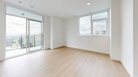 This contemporary 650 square foot apartment in New Westminster offers a well-designed living space with two bedrooms and two bathrooms. The open-concept layout maximizes the use of space, creating a seamless flow between the living areas. The kitchen is a highlight, featuring sleek white cabinetry, stainless steel appliances, and a functional L-shaped design with ample counter space.

Throughout the apartment, light wood flooring adds warmth and continuity. Large windows in the bedrooms and living area flood the space with natural light and provide stunning city views. The primary bedroom, measuring 110 square feet, offers a comfortable retreat.

Both bathrooms are modern and efficient, with one featuring a glass-enclosed shower and the other a bathtub-shower combination. Light neutral tones in the bathrooms complement the overall aesthetic of the apartment.

A standout feature is the private balcony, accessible through sliding glass doors, offering an outdoor extension of the living space. The apartment's location on the 15th floor (unit 1502) ensures excellent views and a sense of urban living.

Storage solutions include built-in closets and kitchen cabinets, making efficient use of the compact 650 square foot floor plan. The clean lines, neutral color palette, and contemporary fixtures throughout create a stylish and inviting urban home.