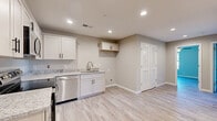 Located at 829 Carthage Highway in Lebanon, Tennessee, this single-floor 2-bedroom, 1-bathroom home offers a thoughtfully designed layout with clean, modern finishes throughout. Light wood-look flooring runs consistently across the entire space, creating a cohesive and bright aesthetic.

The kitchen is a standout feature, outfitted with crisp white shaker-style cabinetry, granite-look countertops, and a full suite of stainless steel appliances including a range, microwave, and dishwasher. Recessed lighting illuminates the space, and an open feel connects the kitchen to the rest of the home.

Both bedrooms are comfortably sized, with the primary bedroom offering generous dimensions. Each bedroom features light-toned walls in a neutral gray-beige palette, ceiling fans with light fixtures, and windows that invite natural light and outdoor views. Five-panel white interior doors add a refined touch throughout.

The home also includes three closets for ample storage, a dedicated utility room, and a full bathroom. The neutral color scheme, clean lines, and updated fixtures give the home a move-in-ready feel. The layout is efficient and practical, making excellent use of the available square footage for comfortable day-to-day living.
