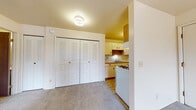 This single-floor unit at 1308 Concord Place Dr in Kalamazoo, Michigan offers a practical and straightforward layout designed for comfortable everyday living. The living area is carpeted and benefits from a sliding glass door that opens onto a private balcony, allowing natural light to fill the space and providing views of the surrounding community. Baseboard heating runs along the walls, ensuring efficient warmth throughout the cooler Michigan months, while a wall-mounted air conditioning unit supports climate control year-round.

The galley-style kitchen is efficiently arranged, featuring cream-toned cabinetry with wood-trimmed accents, a stainless steel sink, ample upper and lower storage, and a full suite of white appliances including a gas range and refrigerator. Tile flooring in the kitchen provides a durable, easy-to-clean surface.

The sleeping area is carpeted and includes double bi-fold closet doors offering generous storage. A window with blinds admits natural light while maintaining privacy. The bathroom is straightforward and clean, with a full soaking tub surrounded by white subway-style tile. Overall, the unit presents a neutral, move-in-ready environment well-suited for a range of occupants.