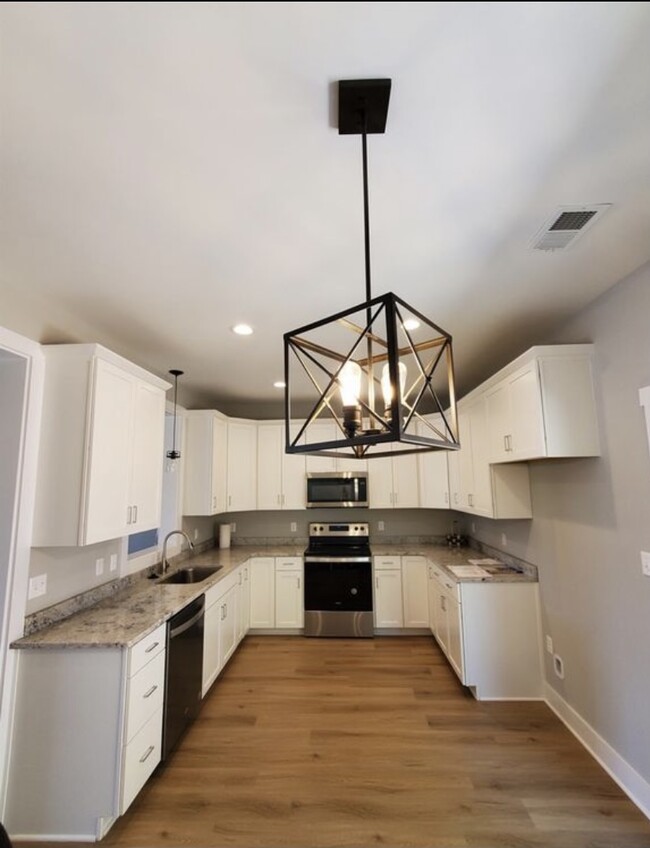 Luxury kitchen with ample storage space and all stainless steel appliances and granite counter tops - 140 Sunburst Villa Dr