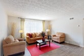 Located at 3901 Campbellton Rd SW in Atlanta, GA, this single-floor, 2-bedroom, 2-bathroom home offers a well-organized layout designed for comfortable everyday living. The spacious living room is a welcoming centerpiece, featuring hardwood-style flooring, a textured ceiling, and a large window with vertical blinds that floods the space with natural light. The adjacent dining area includes a ceiling fan, sliding glass door access to an outdoor balcony, and additional natural light, making it ideal for both casual meals and entertaining. The galley-style kitchen is efficiently arranged with white cabinetry, granite-look countertops, a gas range, dishwasher, and full-size refrigerator, providing ample storage and prep space. Both bedrooms are carpeted and generously sized, with the second bedroom featuring large windows, a ceiling fan, and a built-in closet with bifold doors. The two bathrooms are clean and functional, each equipped with a full soaking tub and tiled surround. A hallway connects the main living areas to the bedrooms and bathrooms, enhancing the home's practical flow. Hardwood-style flooring runs throughout the main living spaces, adding warmth and cohesion to the overall design.