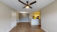 This single-story, 3-bedroom, 2-bathroom residence in Tupelo, Mississippi offers a well-organized layout with consistent design elements throughout. Wood-look luxury vinyl plank flooring runs through the entire unit, providing a cohesive and low-maintenance foundation across all rooms.

The open living area features a ceiling fan with a built-in light and flows directly into the kitchen, which is outfitted with white cabinetry, track lighting, stainless steel appliances including a refrigerator, microwave, and range, and a peninsula with a granite countertop that provides additional workspace and separates the kitchen from the living space. A small chandelier accents the dining area nearby.

Each of the three bedrooms includes ceiling fan lighting, neutral gray-toned walls, and wood-look flooring. The bedrooms offer closet access and are well-proportioned. Natural light enters through windows with blinds in the secondary bedrooms.

Both bathrooms share a similar design, featuring white cabinetry, granite countertops, tiled tub-shower combinations, and wood-look flooring. The primary bedroom includes a private en-suite bathroom with a lighted vanity mirror. The overall aesthetic is clean and contemporary, with a neutral color palette throughout.