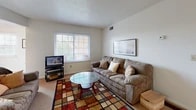 Located at 203 S Mercer Rd in Bowling Green, Ohio, this two-bedroom, one-bathroom single-floor residence offers a practical and well-organized layout across a comfortable footprint. The living room provides a welcoming gathering space with carpet flooring, a large window that brings in natural light, and views of the surrounding greenery. Adjacent to it, the dining area features tile flooring, a ceiling fan, and its own window, creating a bright and airy space for meals. The kitchen is equipped with warm oak cabinetry, ample counter space, tile flooring, and a gas range, with a dedicated closet/pantry for additional storage. The two bedrooms are carpeted and well-lit, each featuring windows with blinds and closet access. The primary bedroom offers generous space, while the second bedroom functions equally well as a guest room or home office. The shared bathroom features tile flooring, a vanity with oak cabinetry, and connects conveniently to the hallway. Two hallways guide the flow of the unit efficiently. A private balcony overlooks a landscaped courtyard with green space, providing a pleasant outdoor retreat. The overall ambiance is clean, neutral, and move-in ready.
