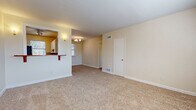 Located on Pennsylvania Ave in Savannah, GA, this compact yet functional single-floor unit offers three bedrooms, one bathroom, and a combined kitchen and living area connected by a hallway. The layout makes efficient use of its footprint, with each room designed for practical everyday living.

The open living area features neutral beige carpet, soft wall tones, and a small chandelier overhead. A half-wall partition with a wooden counter separates the living space from the kitchen, which is equipped with white cabinetry, granite-style countertops, a stainless steel range, and a mosaic tile backsplash in blue and brown tones. Tile flooring and a window with natural light complete the kitchen.

Each of the three bedrooms is carpeted and finished in warm neutral tones. The primary bedroom benefits from two windows, allowing ample natural light, while the additional bedrooms each feature at least one window with blinds. All rooms offer clean, understated finishes with white baseboards throughout.

The bathroom is a standout feature, fully clad in bold black-and-white checkerboard tile from floor to wall. It includes a soaking tub, wall-mounted sink, and a window that brings in natural light, creating a striking retro aesthetic within the otherwise understated unit.