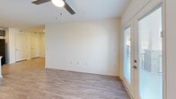 Located at 2036 S Hamilton St in Roanoke Rapids, NC, this single-story home offers three bedrooms and two full bathrooms within a thoughtfully designed floor plan. Throughout the home, durable wood-look luxury vinyl flooring and crisp white walls create a clean, cohesive aesthetic.

The open-concept kitchen and living area serves as the heart of the home. The kitchen is outfitted with taupe shaker-style cabinetry, granite-look countertops, black appliances including a range and refrigerator, a peninsula with a sink, and recessed lighting. The living room features a ceiling fan with light and French doors that open to a balcony, inviting natural light and outdoor views.

Each bedroom is finished with matching flooring and ceiling fans. The primary bedroom includes access to a dedicated walk-in closet equipped with wire shelving and hanging rods. Additional bedrooms are generously sized with windows providing natural light.

Both bathrooms echo the same design language, featuring dark wood vanities with granite-look countertops, large mirrors, and a combination tub and shower. One bathroom also includes a medicine cabinet and stylish bar lighting above the mirror. The consistent, modern finishes throughout give the home a fresh, move-in-ready feel.