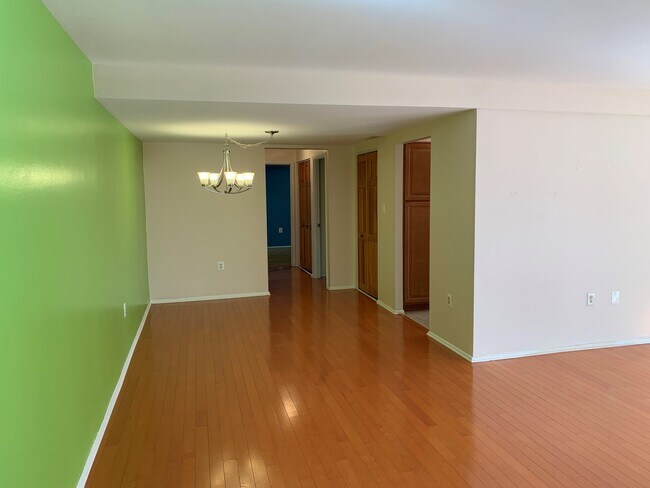 Dining room with a view of the master bedroom at the end of the hallway. - 3366 Woodburn Rd